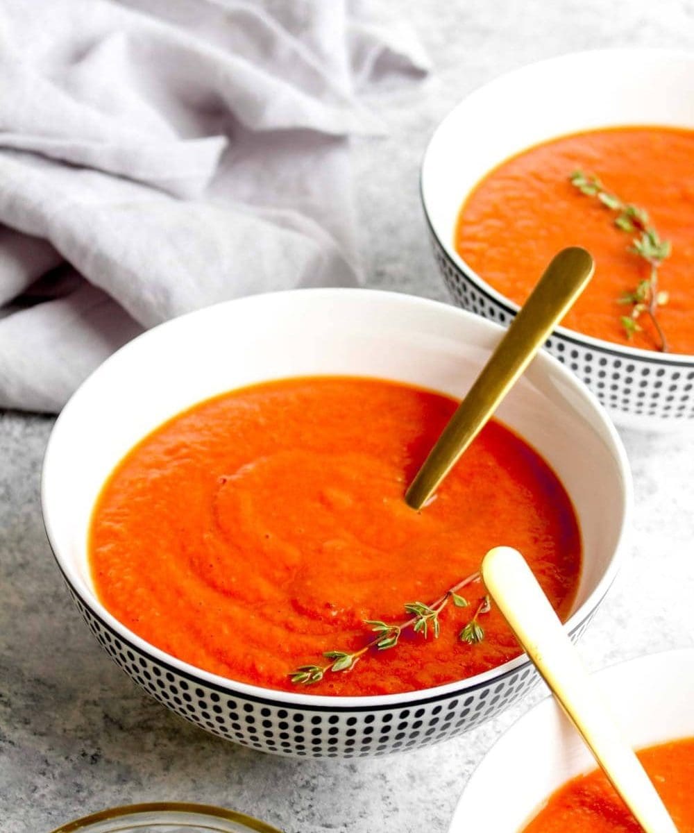 Three bowls of roasted tomato soup.