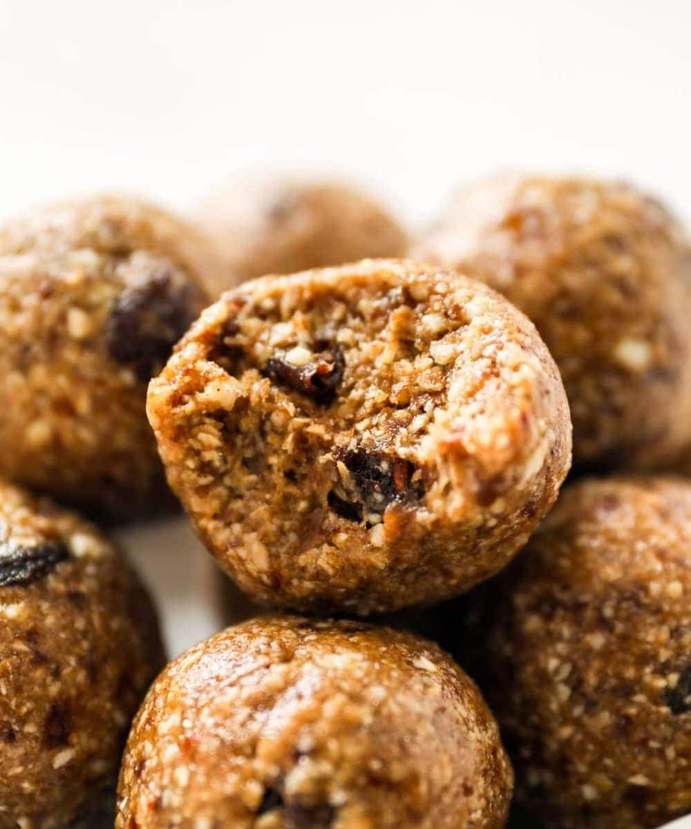A bite out of an oatmeal raisin cookie dough bite.