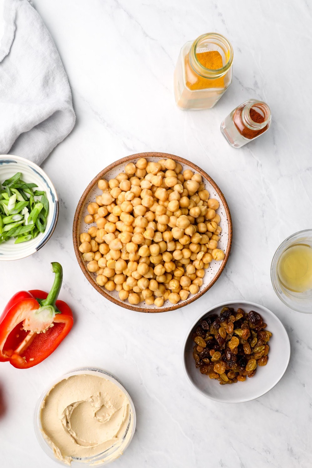 Ingredients needed to make Curry Chickpea Salad in bowls.