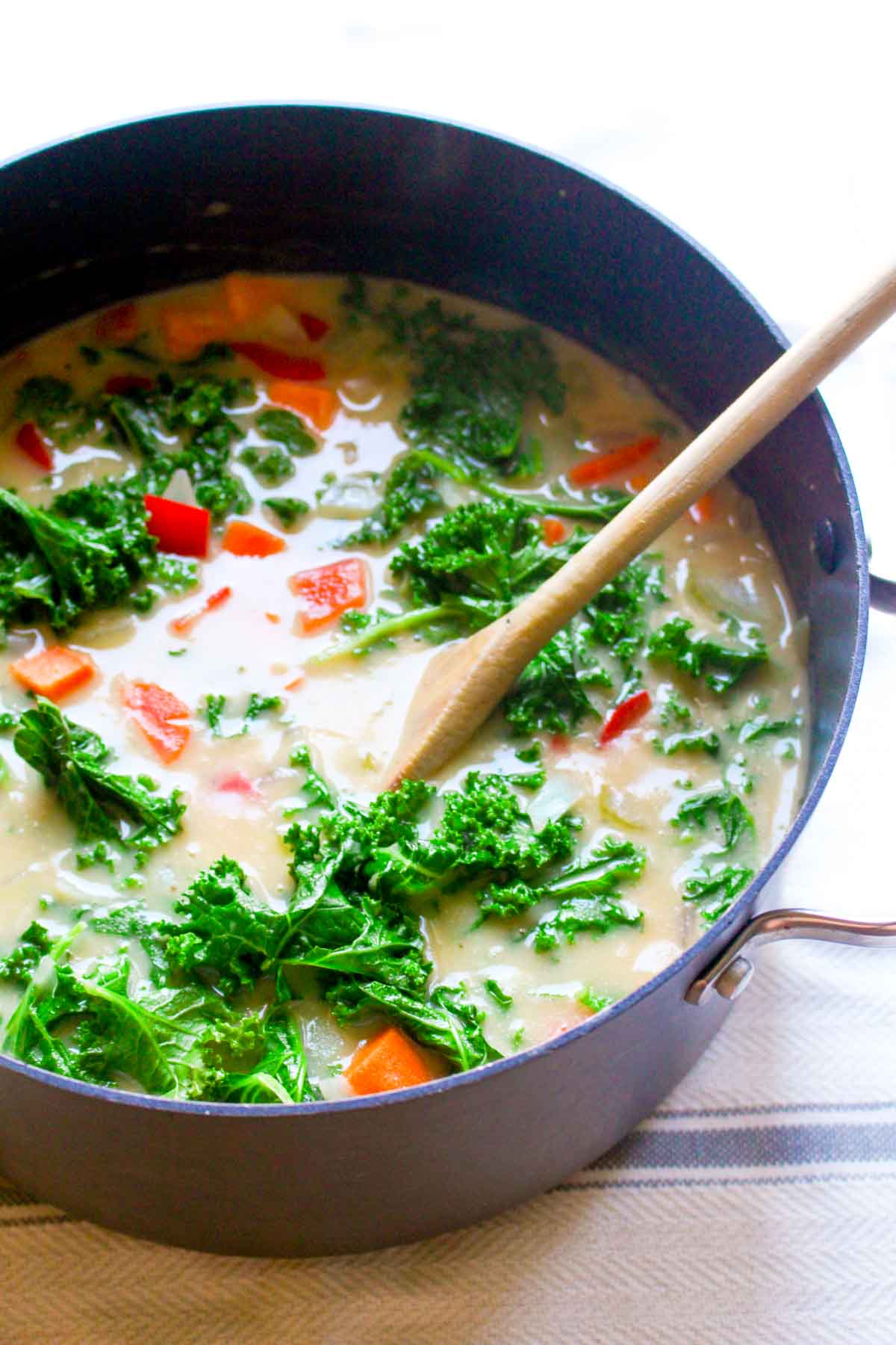 You will never believe this Sweet Potato Kale Chowder Recipe is secretly healthy! It is SO incredibly creamy. Find out the secret trick for thick and creamy dairy-free soup! | CatchingSeeds.com