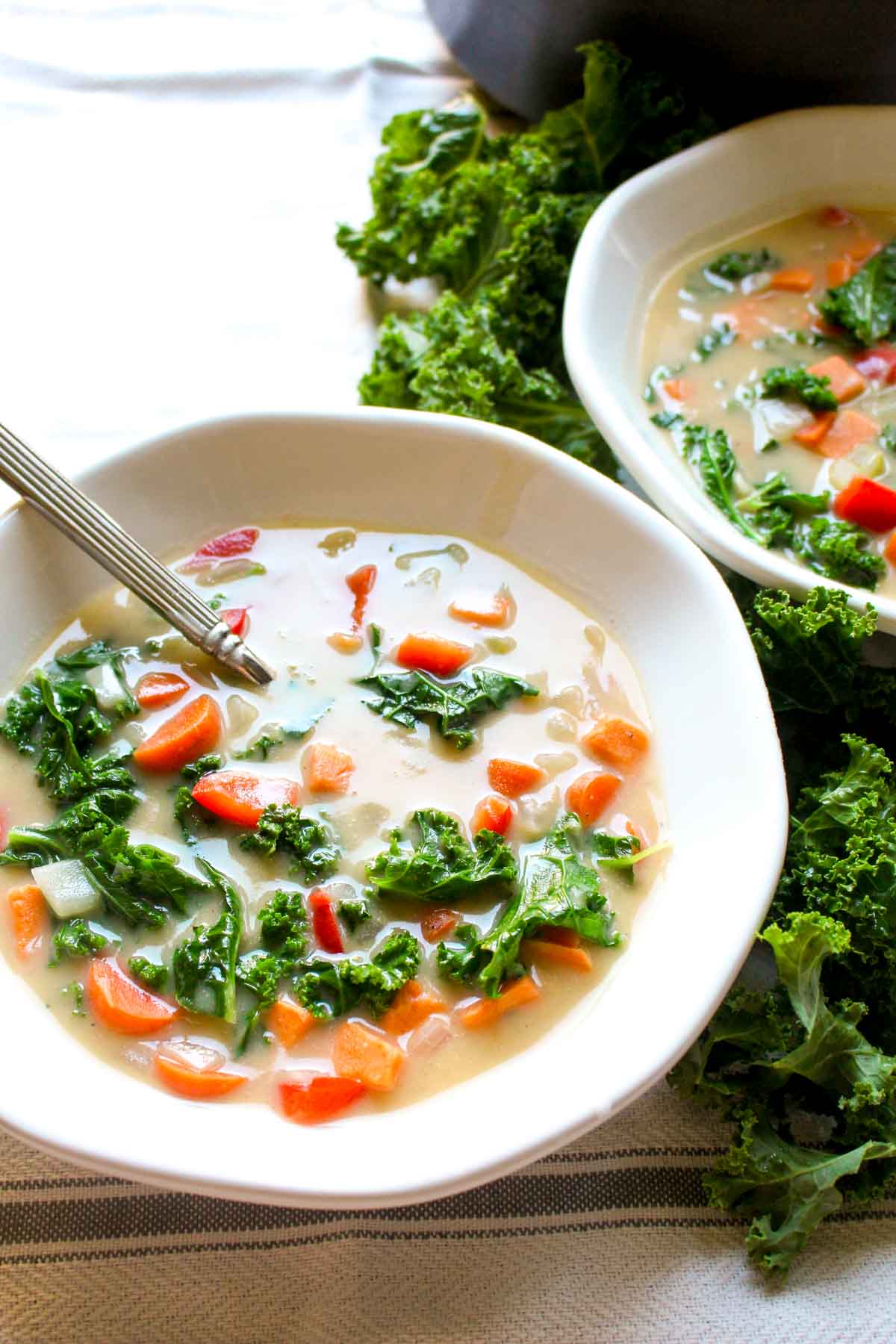 You will never believe this Sweet Potato Kale Chowder Recipe is secretly healthy! It is SO incredibly creamy. Find out the secret trick for thick and creamy dairy-free soup! | CatchingSeeds.com