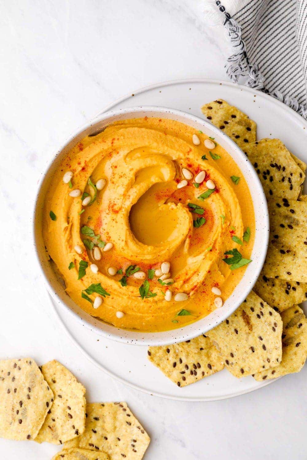 Sweet Potato Hummus in a bowl with olive oil and paprika.