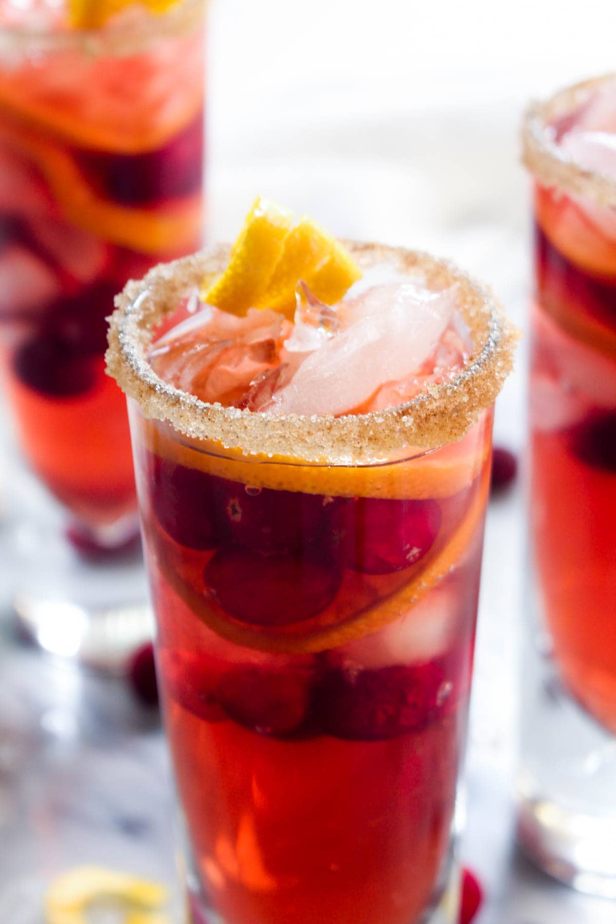 This Kombucha Sangria recipe is a non-alcoholic party drink. Effervescent kombucha gives it a sophisticated feel and cranberries and orange slices infuse this healthy drink with holiday flavor.