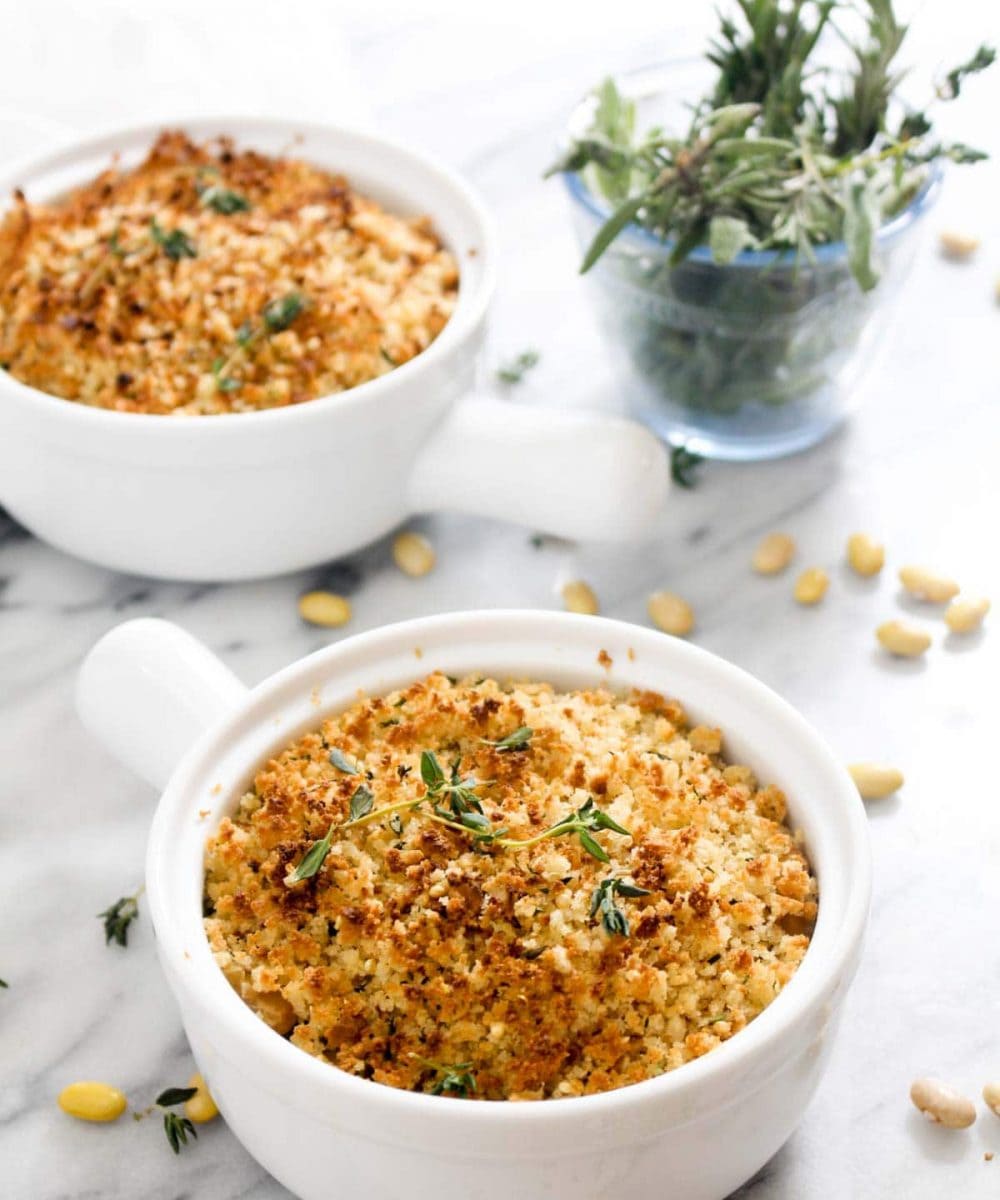 This quick 30 minute Easy Vegan Cassoulet recipe is bursting with French flavor. Beans are slow simmered in a flavorful sauce and then topped with golden brown breadcrumbs to make the perfect side to dinner. A few vegan hacks allow us to make this recipe feel traditional while omitting the meat. | CatchingSeeds.com