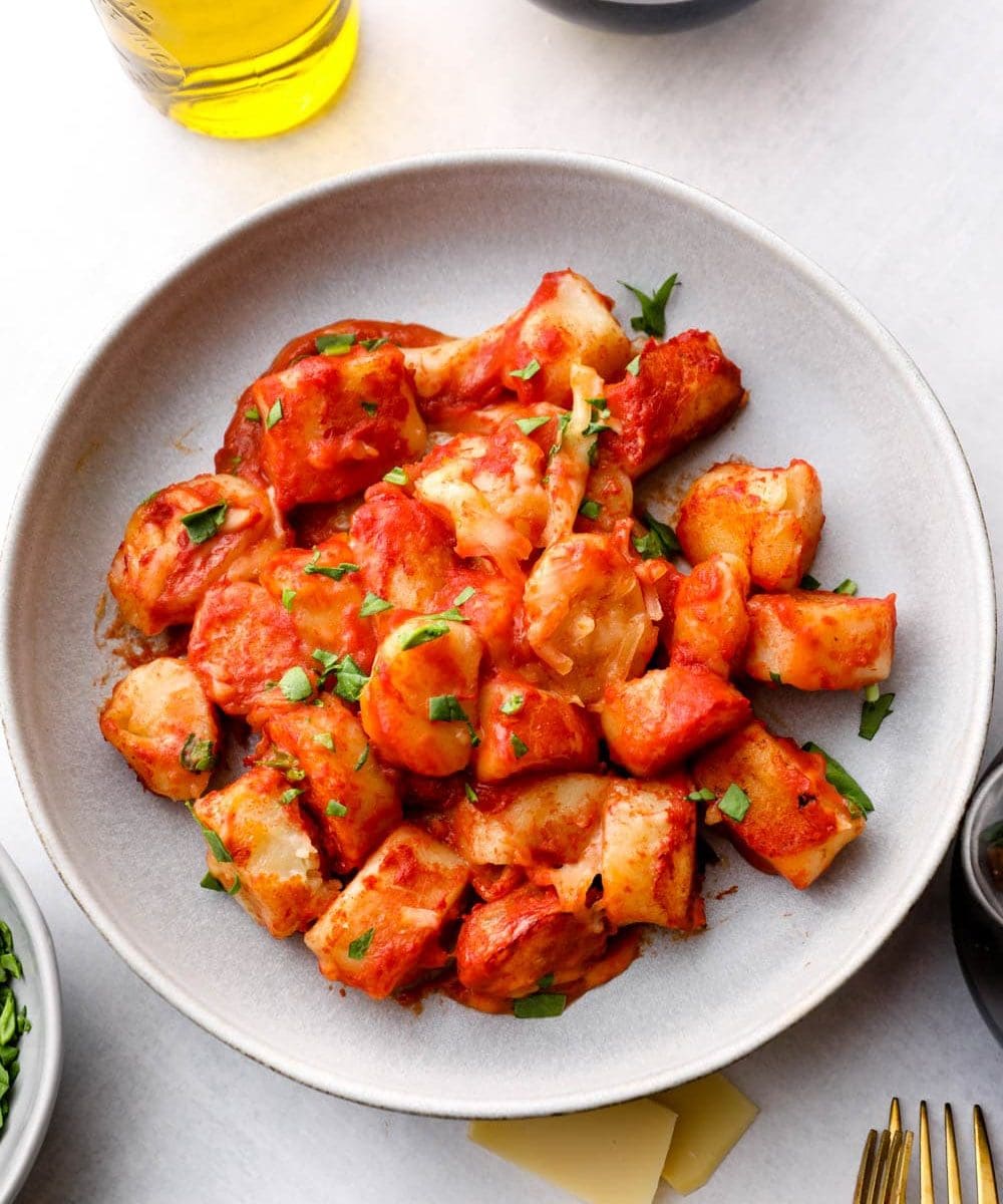 Gluten Free Gnocchi served with tomato sauce and vegan cheese.