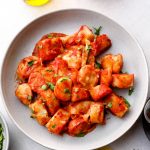 Gluten Free Gnocchi served with tomato sauce and vegan cheese.