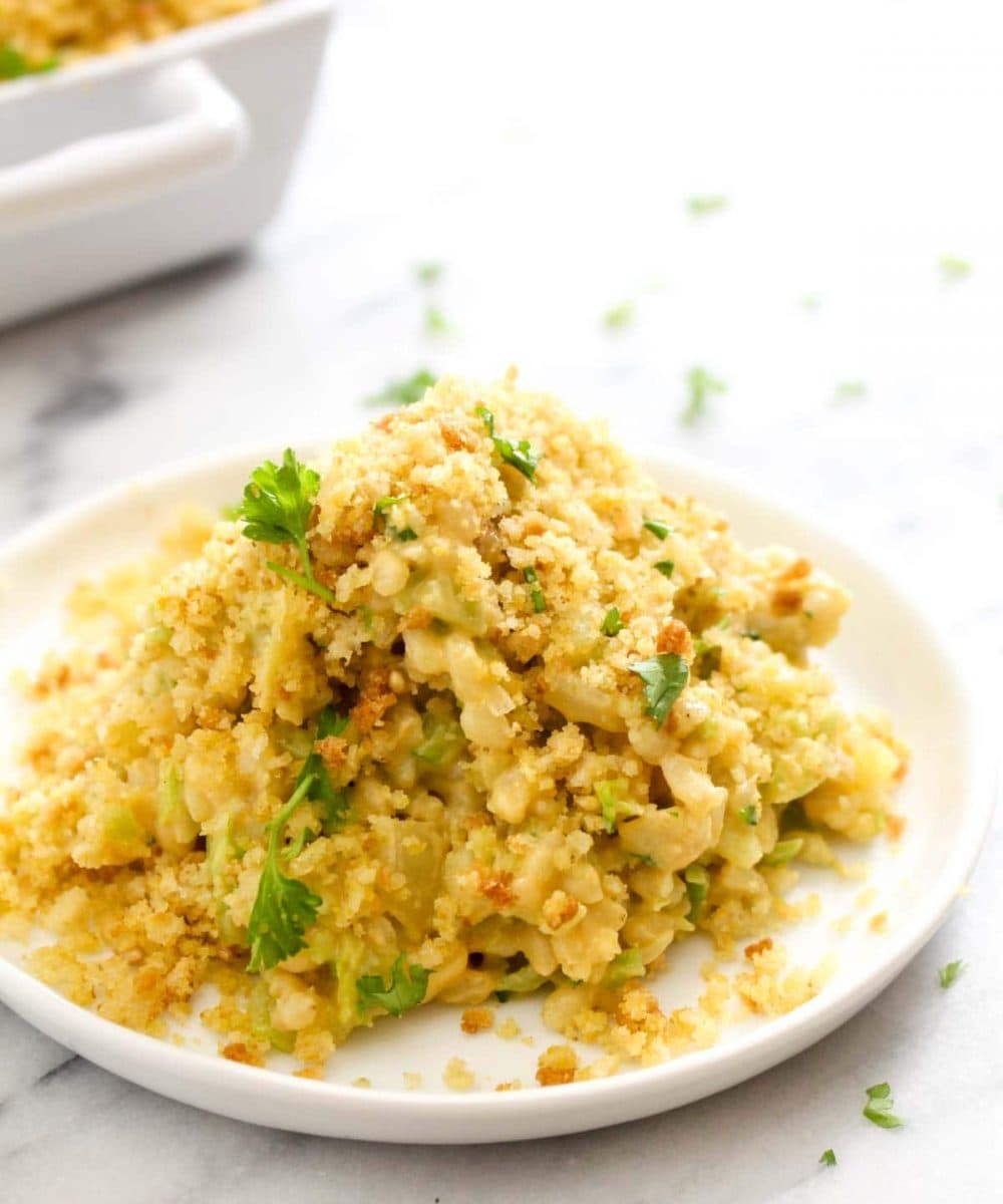 This Cheesy Broccoli Rice Casserole is a hearty and creamy dish that satisfies that itch for comfort food while being completely healthy, gluten-free, and vegan! This quick dish only takes 30 minutes to make, including the time it takes to whip up the cheese sauce. | CatchingSeeds.com
