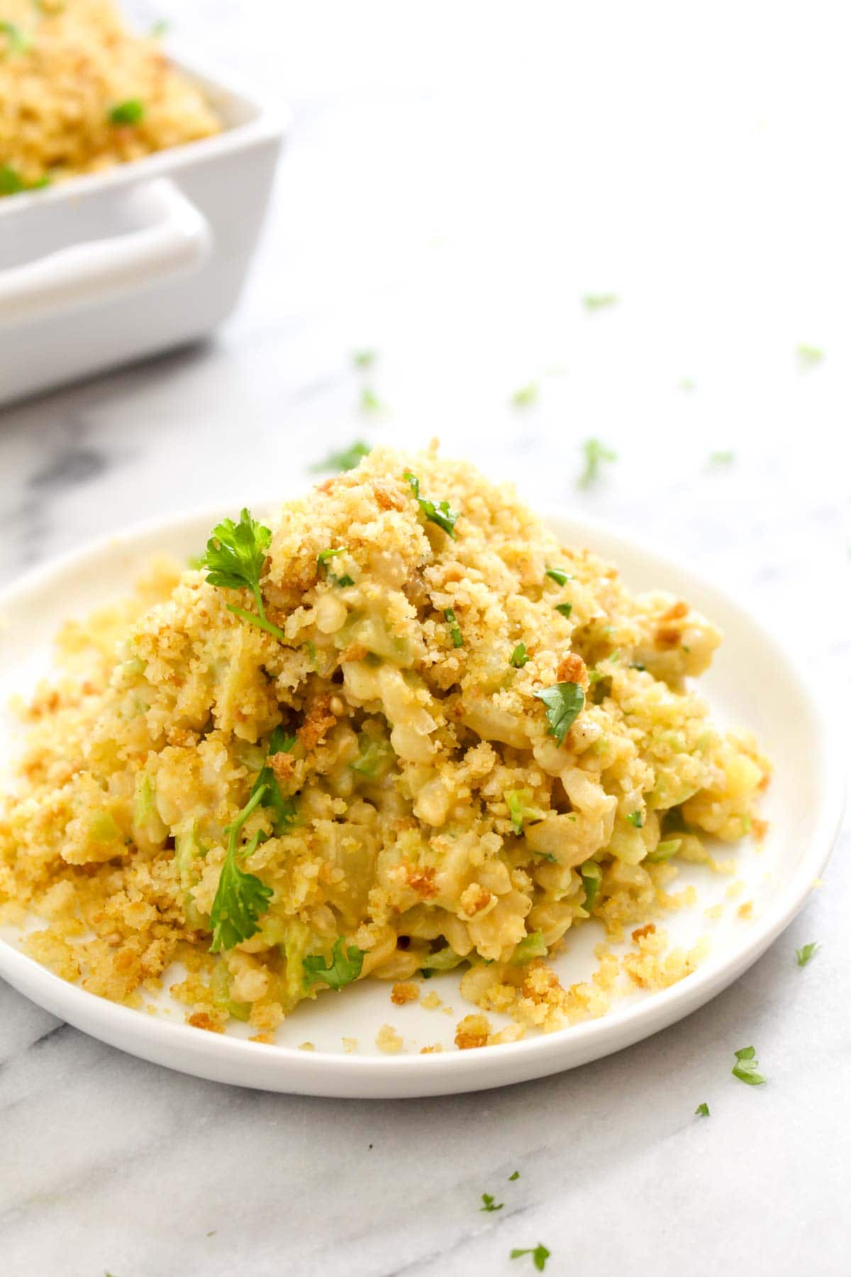 This Cheesy Broccoli Rice Casserole is a hearty and creamy dish that satisfies that itch for comfort food while being completely healthy, gluten-free, and vegan! This quick dish only takes 30 minutes to make, including the time it takes to whip up the cheese sauce. | CatchingSeeds.com