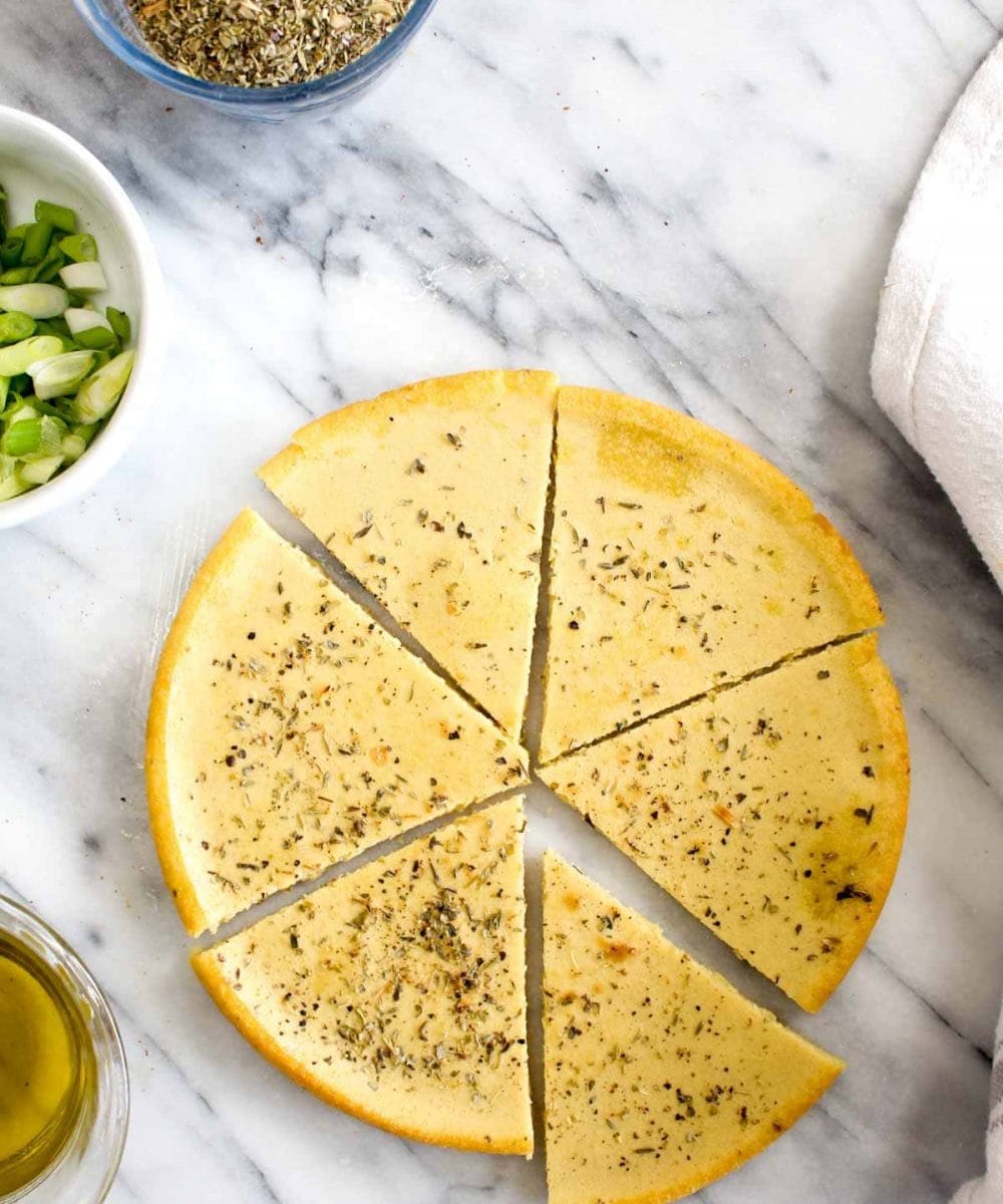 This Easy Homemade Socca Recipe is a tasty and delicious flatbread! It can be made in jut a few minutes and makes a great vegan and gluten free side for soups and salads! | CatchingSeeds.com