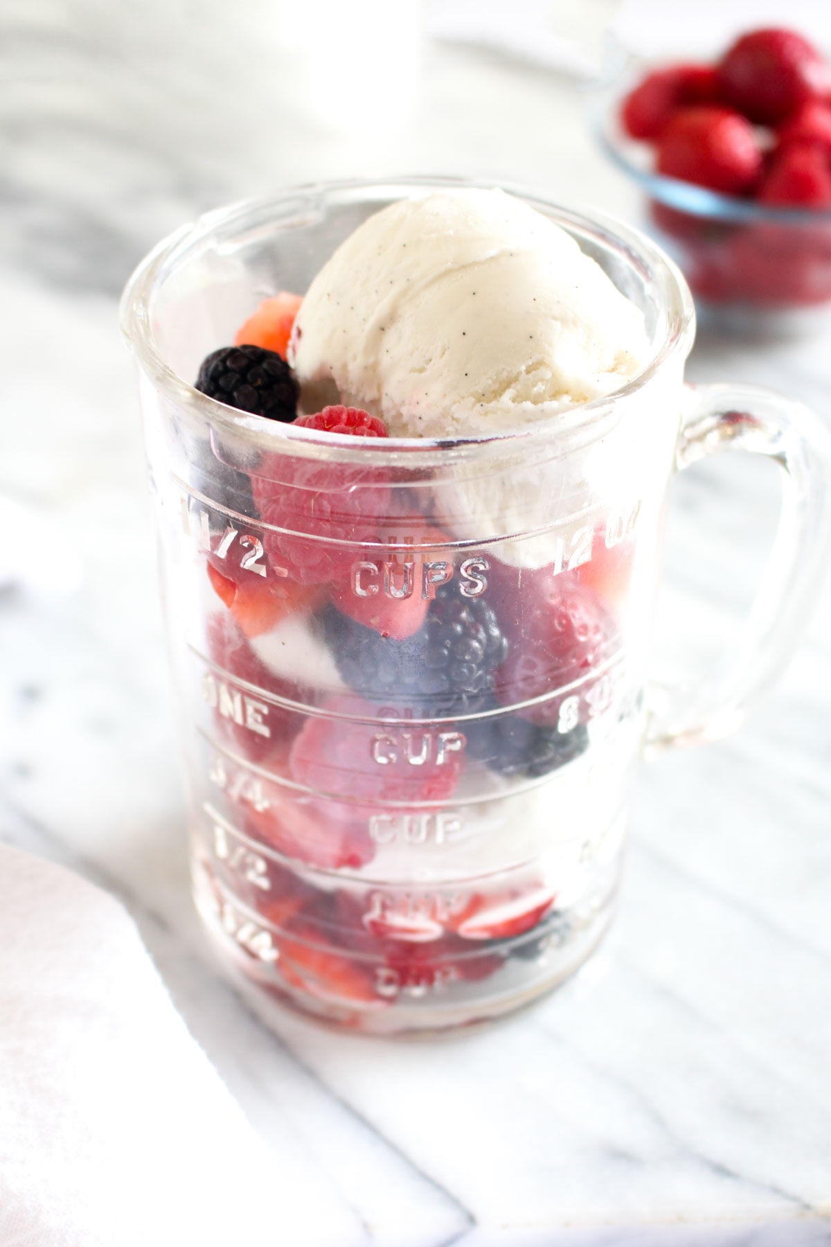 This Kombucha Float with Summer Berries is a 3 ingredient summertime dessert. Probiotic kombucha gets poured over coconut ice cream and fresh berries for an easy dairy free recipe. | CatchingSeeds.com