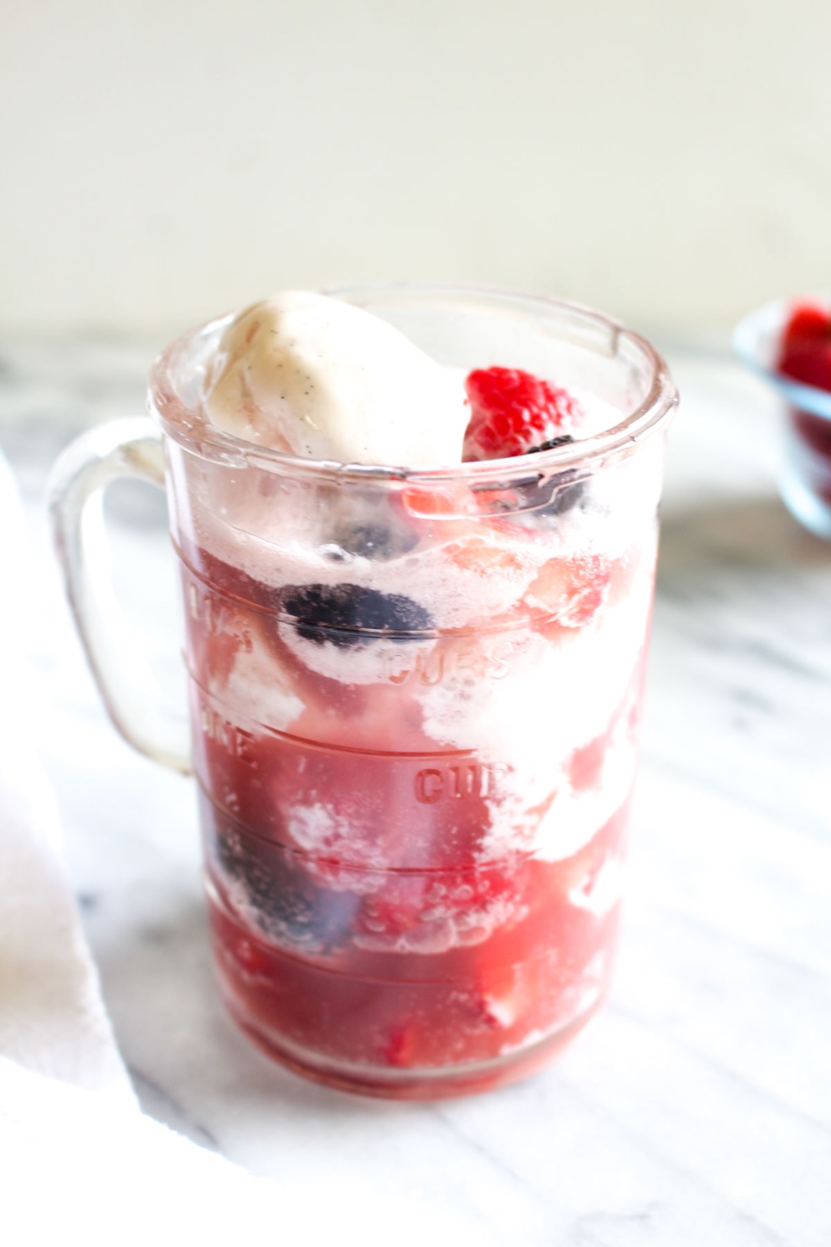 This Kombucha Float with Summer Berries is a 3 ingredient summertime dessert. Probiotic kombucha gets poured over coconut ice cream and fresh berries for an easy dairy free recipe. | CatchingSeeds.com