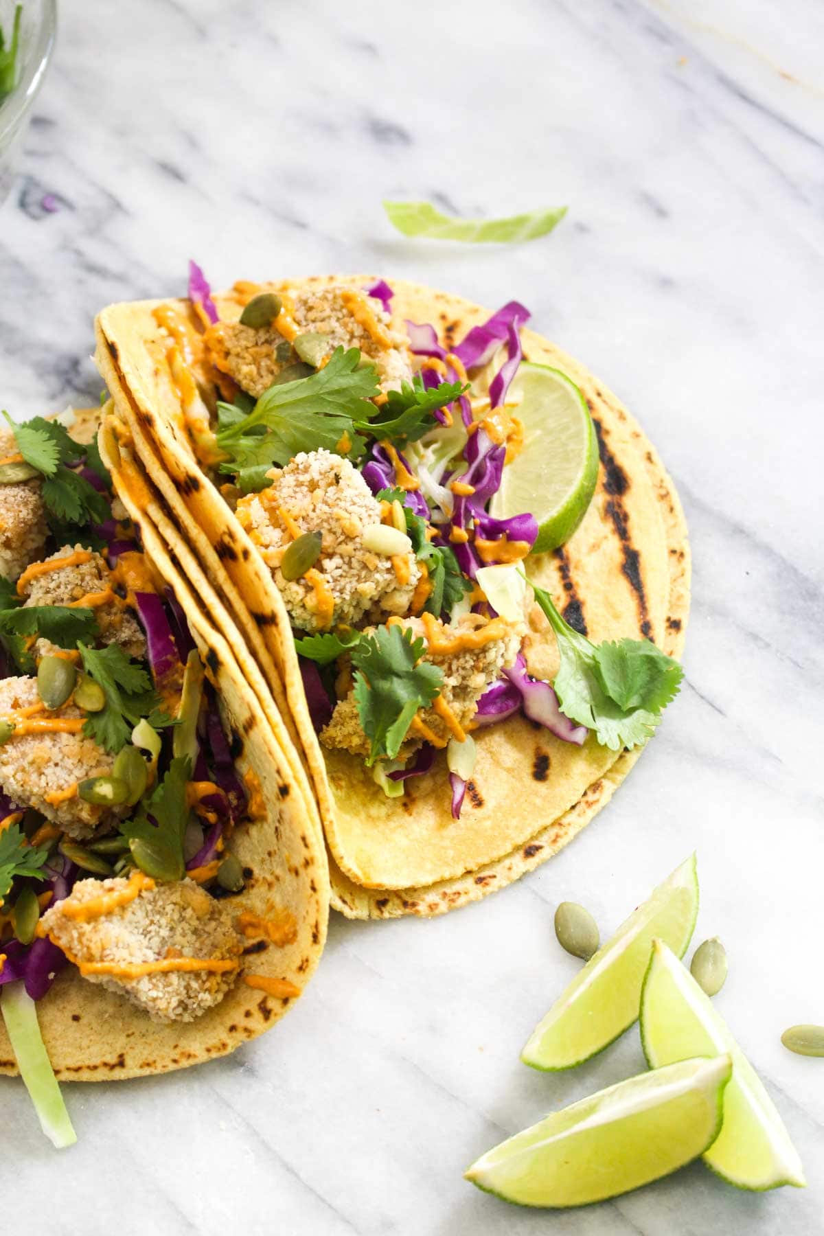 These Crispy Pumpkin Tacos will spice up taco Tuesday with their smokey Chipotle Lime Crema. This recipe is vegan, gluten free, and healthy! | CatchingSeeds.com