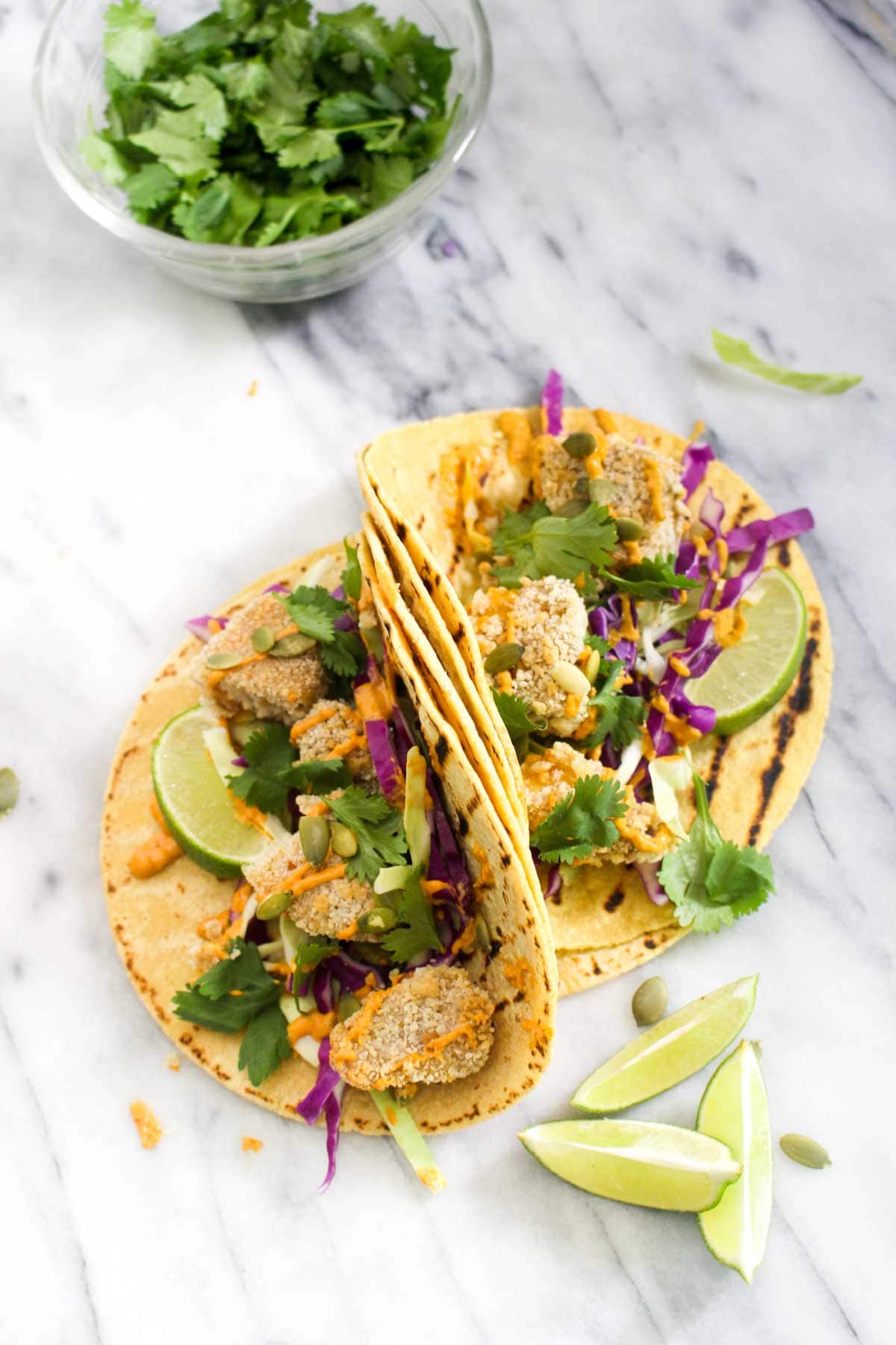 These Crispy Pumpkin Tacos will spice up taco Tuesday with their smokey Chipotle Lime Crema. This recipe is vegan, gluten free, and healthy! | CatchingSeeds.com