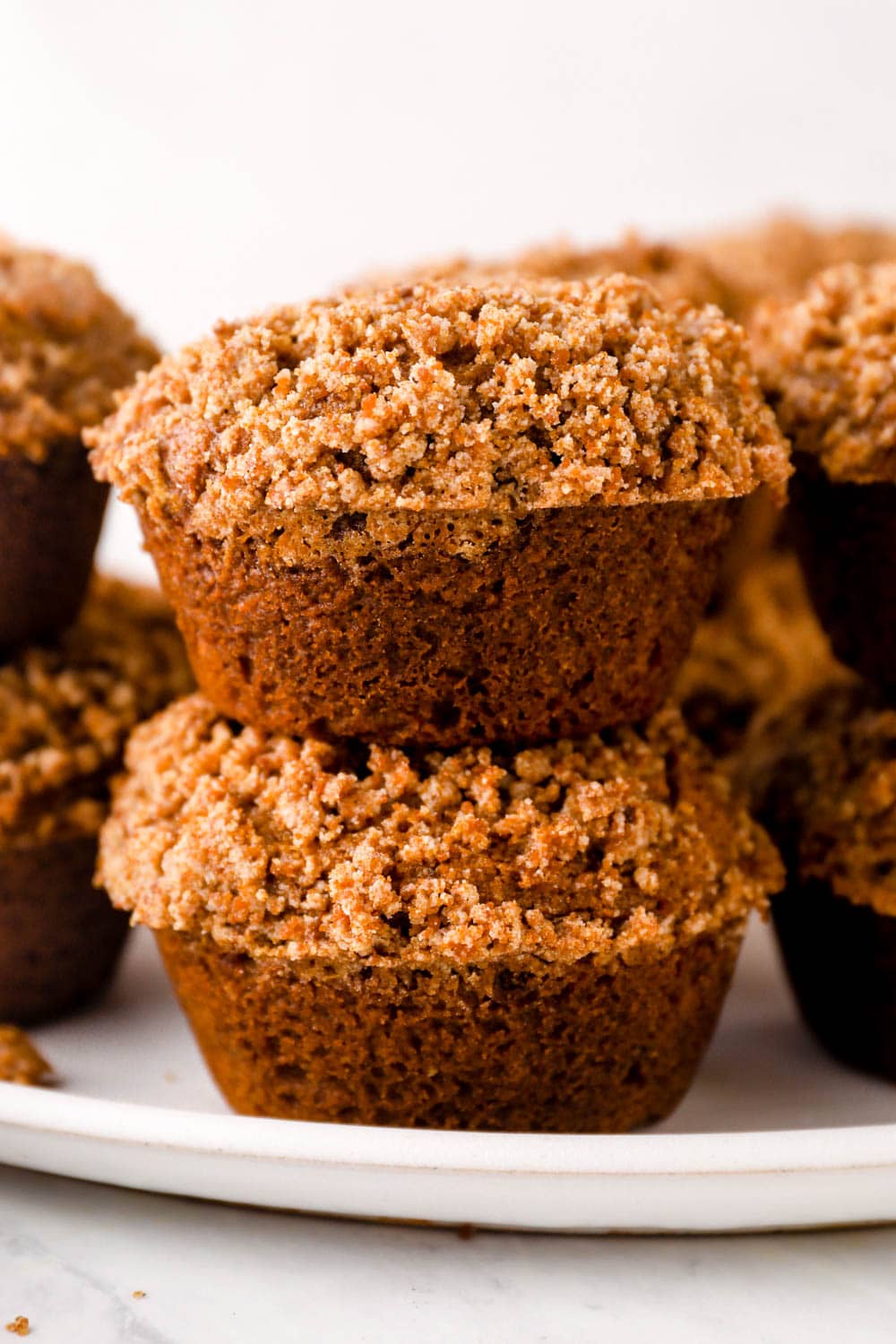 Two stacked Gluten Free Pumpkin Muffins with cinnamon and ginger.