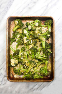 Parmesan Garlic Roasted Broccoli is a simple 4 ingredient healthy recipe that goes with any meal. The garlic flavor is unreal. And this side happens to be paleo, vegan, grain-free, gluten-free, dairy-free, and healthy to boot! | CatchingSeeds.com