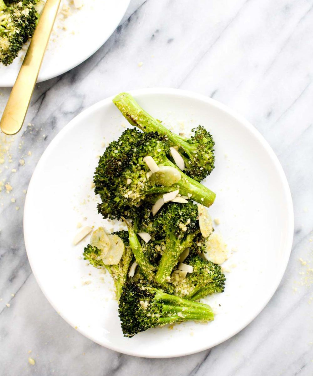 Parmesan Garlic Roasted Broccoli is a simple 4 ingredient healthy recipe that goes with any meal. The garlic flavor is unreal. And this side happens to be paleo, vegan, grain-free, gluten-free, dairy-free, and healthy to boot! | CatchingSeeds.com