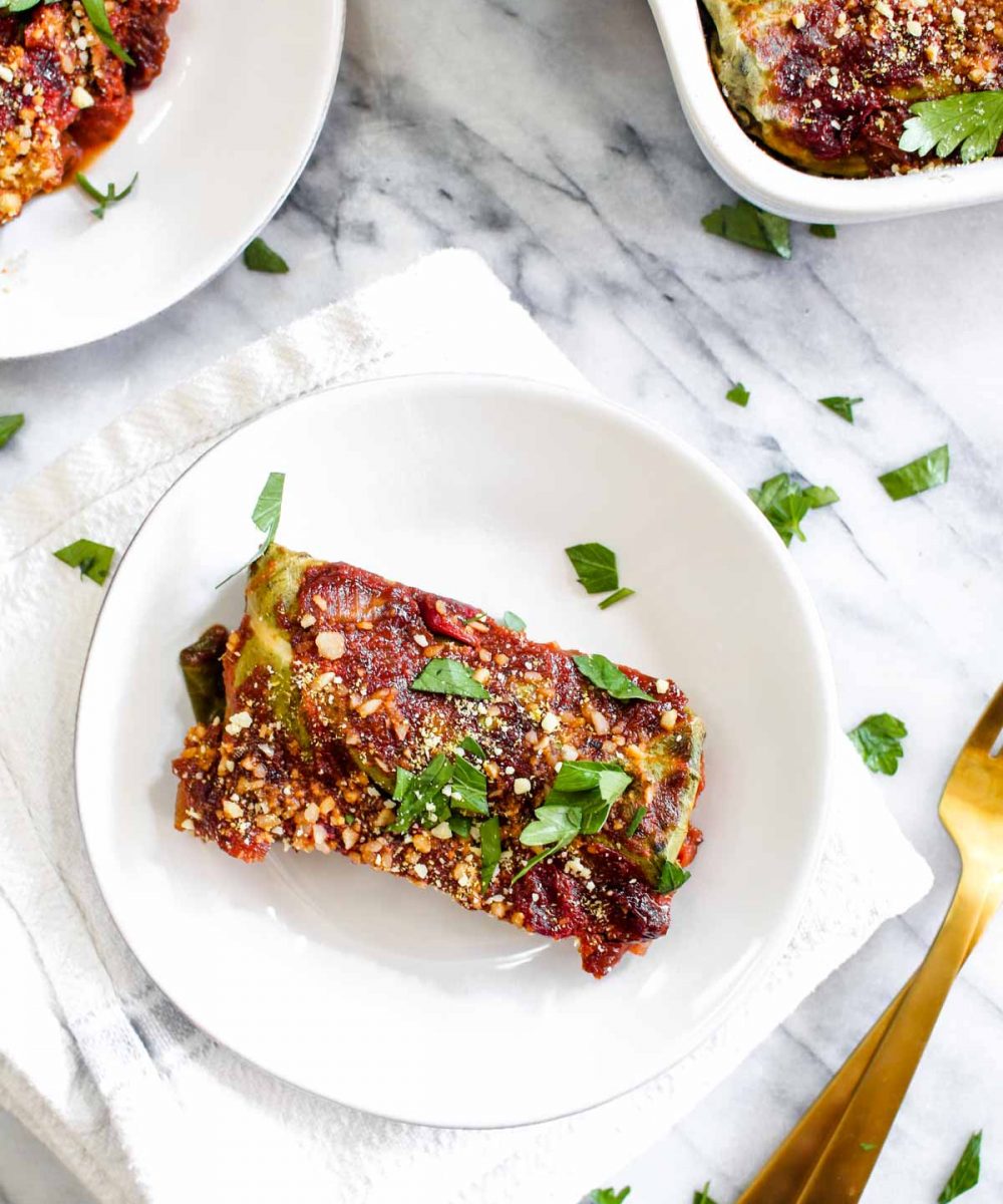Fall Harvest Collard Rolls with Cranberry Tomato Sauce is a healthy recipe filled with butternut squash, pecans, and creamy almond ricotta. A vegan, paleo, and gluten-free Thanksgiving recipe that everyone will love! | CatchingSeeds.com