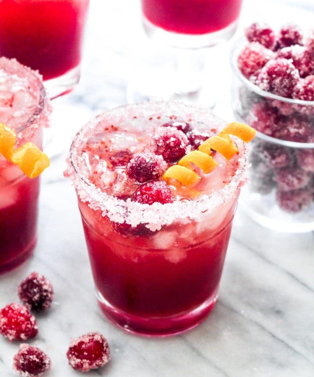 Cranberry Orange Gin Fizz is a festive cocktail filled with Holiday flavor! This easy drink recipe uses a naturally sweetened homemade cranberry sauce for a big punch of flavor. | CatchingSeeds.com