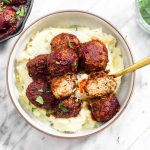 Veggie Meatballs with Cranberry Barbecue Sauce are a proper plant-based Thanksgiving entree recipe. This healthy gluten-free dish is bursting with savory-sweet flavor thanks to a simple homemade BBQ sauce.