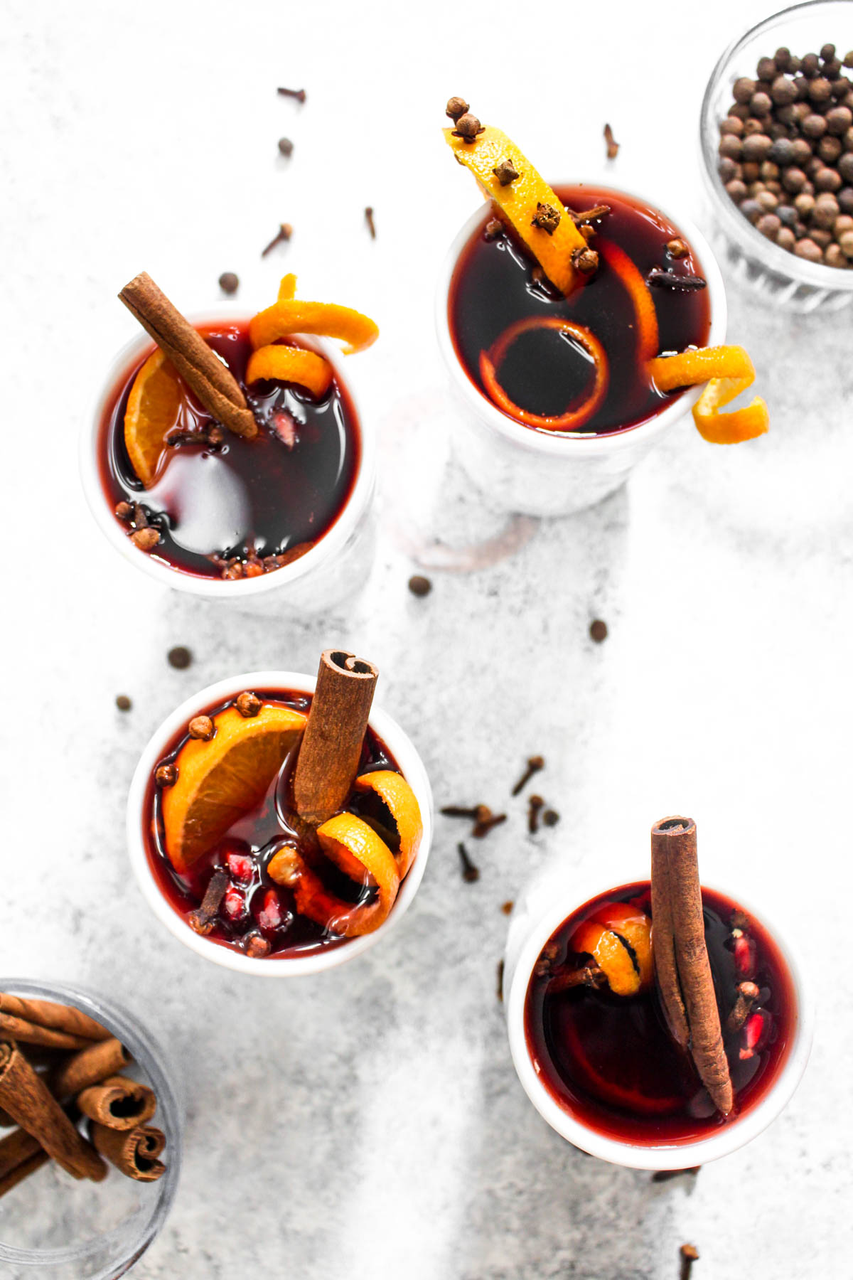 Crock Pot Hot Spiced Wine is an easy 5 ingredient Christmas cocktail. Red wine gets infused with cinnamon, clove, orange, and pomegranate all in the slow cooker for an impressive hands off holiday drink. | CatchingSeeds.com