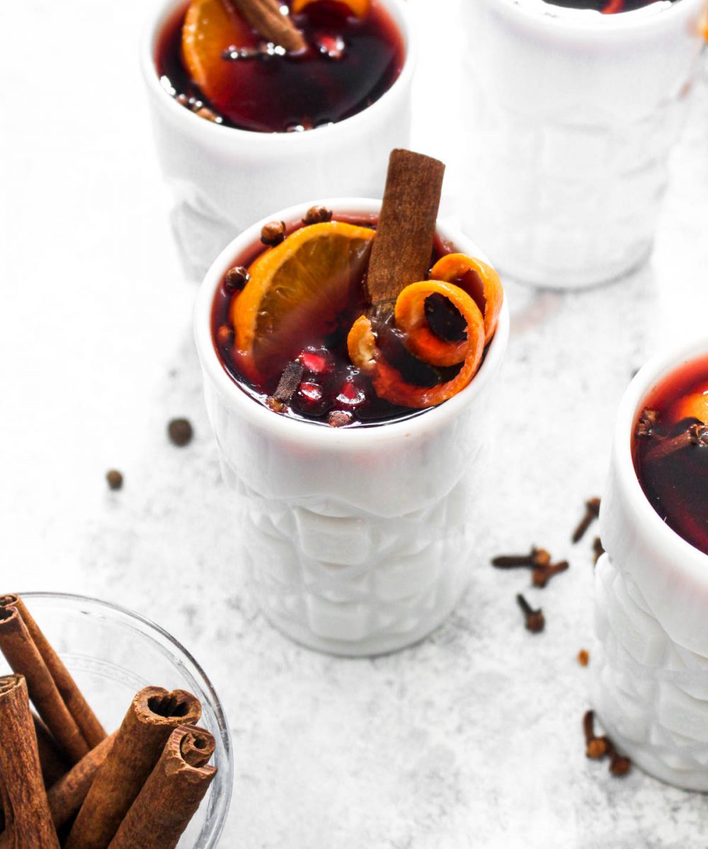 Crock Pot Hot Spiced Wine is an easy 5 ingredient Christmas cocktail. Red wine gets infused with cinnamon, clove, orange, and pomegranate all in the slow cooker for an impressive hands off holiday drink. | CatchingSeeds.com