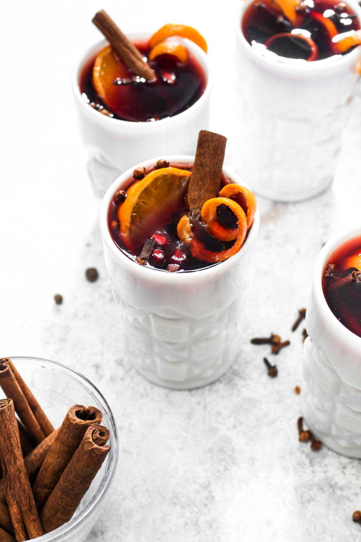 Crock Pot Hot Spiced Wine is an easy 5 ingredient Christmas cocktail. Red wine gets infused with cinnamon, clove, orange, and pomegranate all in the slow cooker for an impressive hands off holiday drink. | CatchingSeeds.com
