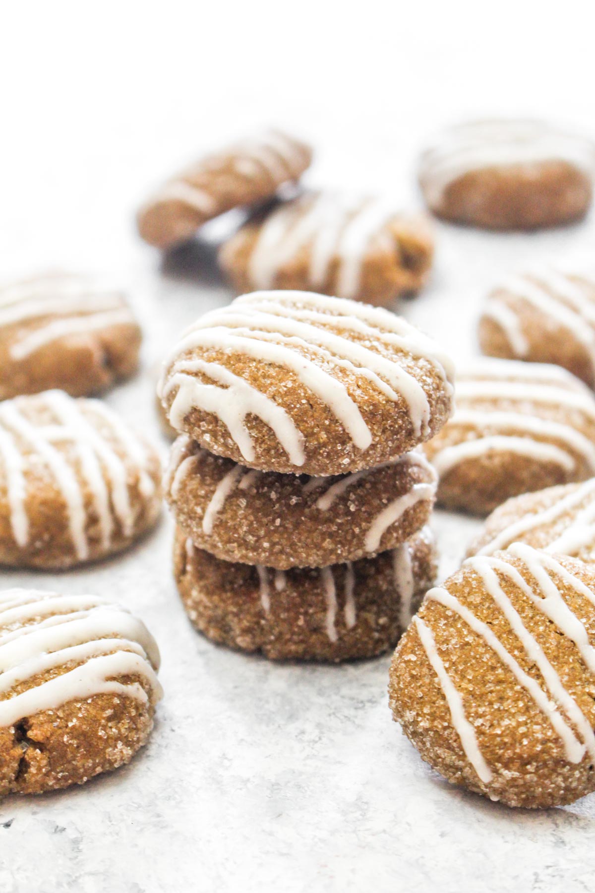 These Soft Ginger Cookies with Eggnog Glaze are a gluten free and vegan holiday dessert that everyone can enjoy! The soft spiced cookie gets topped with a sweet and creamy glaze. A secret ingredient keeps these cookies soft! | CatchingSeeds.com