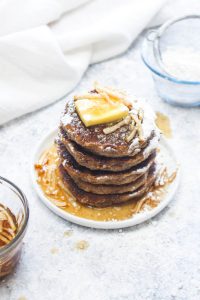 Cinnamon Pancakes with Pear Maple Syrup are a light and fluffy gluten free and vegan pancake recipe! This healthy breakfast gets smothered in a 10 minute holiday spiced syrup. Allergy friendly pancakes are hard to make! They are often gummy and flat, but this easy recipe uses a few secret ingredients to make perfect pancakes every time! | CatchingSeeds.com