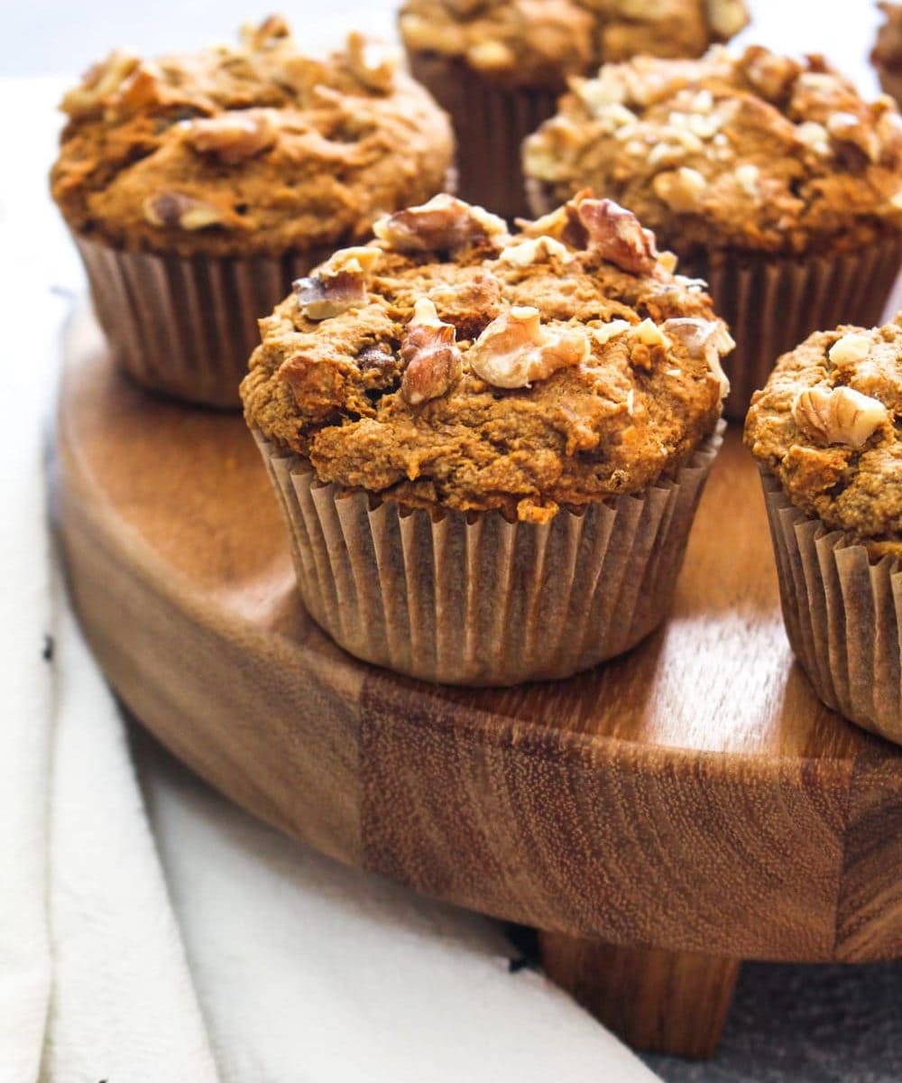 Gluten Free Morning Glory Muffins are a soft and tender pastry that is filled with flavors including nuts, dried fruit, orange zest, and carrots. This recipe is made with whole grains and natural sweeteners for a satiating breakfast or snack! | CatchingSeeds.com