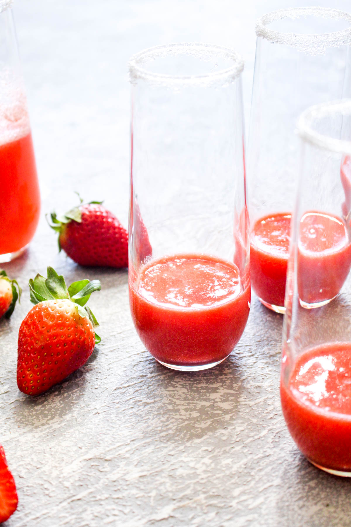This quick and easy Strawberry French 75 cocktail is a fruity spin on the lemon flavored classic. This light drink recipe uses just 3 ingredients and is sweetened with fruit only! Its the perfect bubbly spring beverage. | CatchingSeeds.com