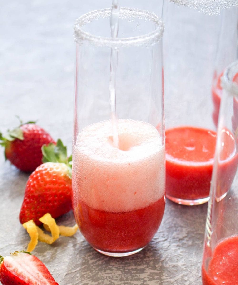 This quick and easy Strawberry French 75 cocktail is a fruity spin on the lemon flavored classic. This light drink recipe uses just 3 ingredients and is sweetened with fruit only! Its the perfect bubbly spring beverage. | CatchingSeeds.com