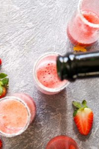 This quick and easy Strawberry French 75 cocktail is a fruity spin on the lemon flavored classic. This light drink recipe uses just 3 ingredients and is sweetened with fruit only! Its the perfect bubbly spring beverage. | CatchingSeeds.com