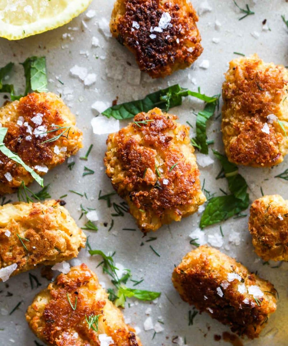Mediterranean Chickpea Cauliflower Tots are a fun and healthy spin on traditional tots! This side dish gets golden brown and crispy on the outside and is melt in your mouth on the inside. Plus, this recipe sneaks in some extra veggies, is gluten free, and vegan! | CatchingSeeds.com