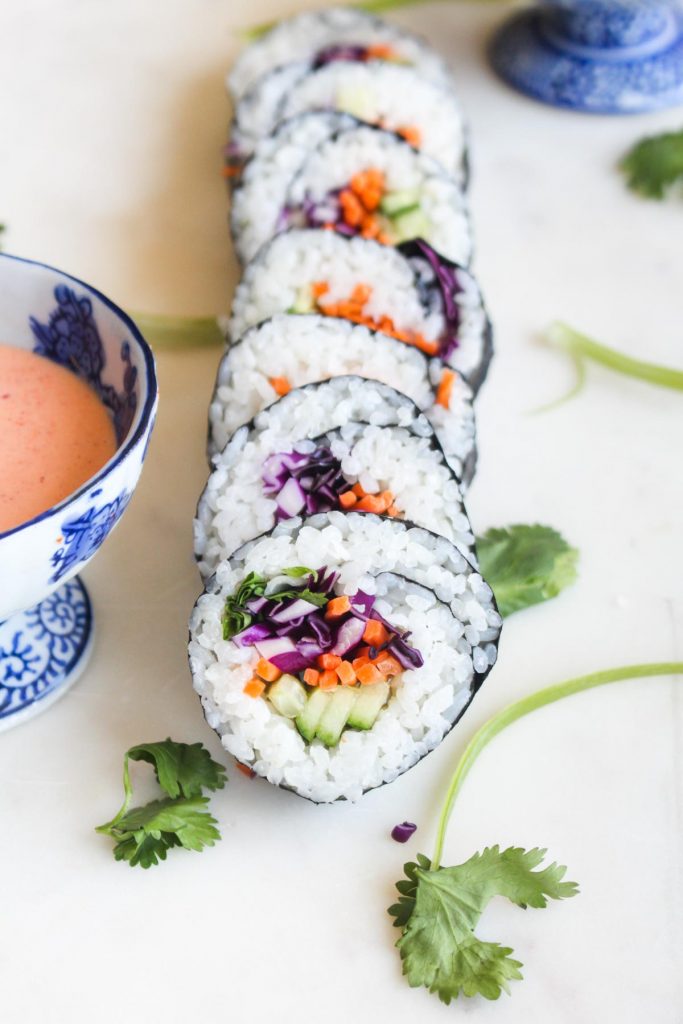 Homemade Veggie Sushi is easier than you think! Customize your roll with your favorite veggies and wow your friends by bringing the sushi bar home with this vegan and gluten free recipe. | CatchingSeeds.com