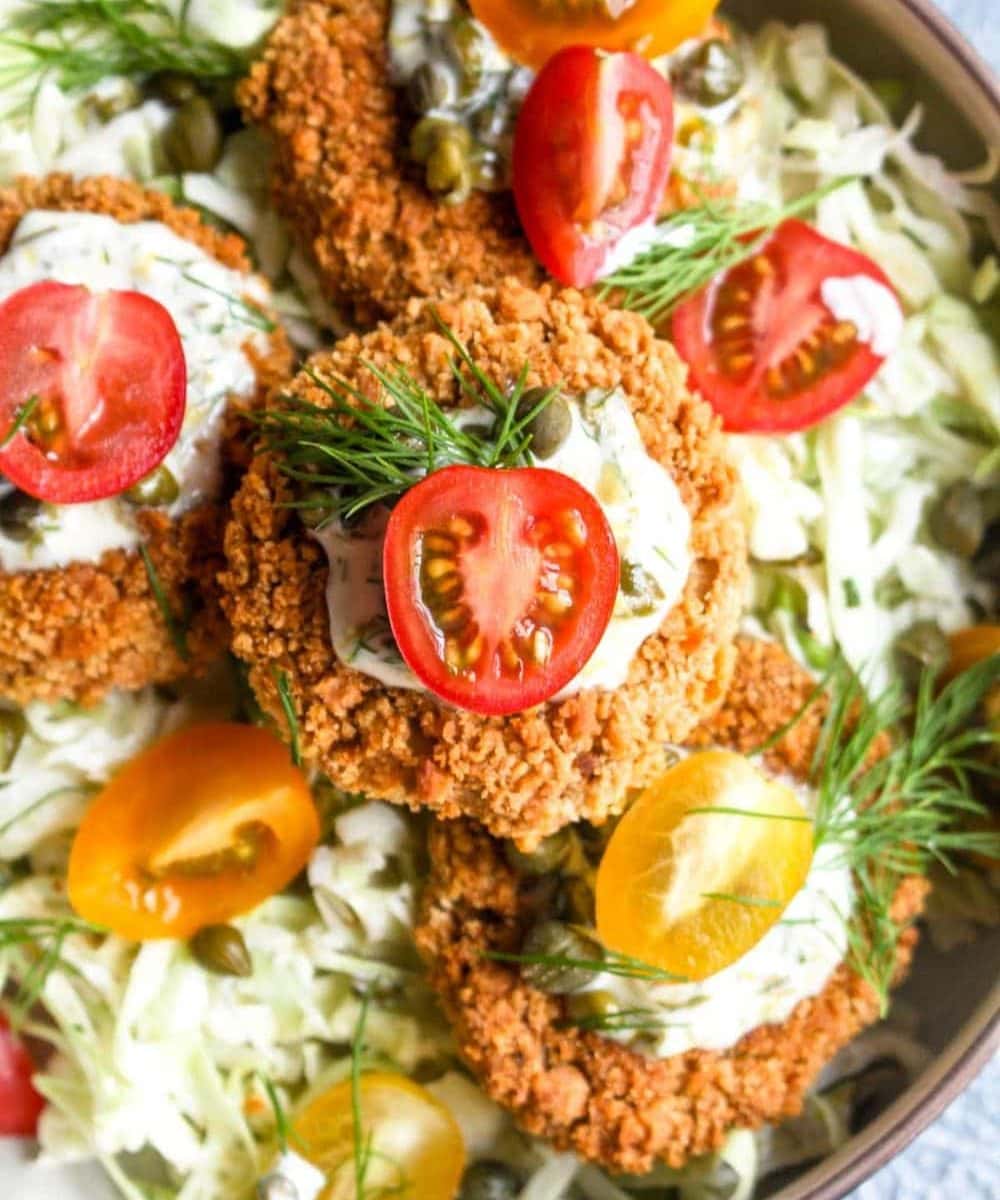 Heart Of Palm Cakes with Caper Aioli are a fun veggie packed spin on a crab cake. This recipe is vegan, gluten, free and full of flavor! The caper aioli is the perfect bright and creamy compliment to the crispy cakes. | CatchingSeeds.com