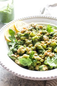 This no-cook summer salad is bursting with bright basil pesto, crunchy cucumbers, creamy beans, and peppery arugula. Perfect for hot summer nights, this gluten free and vegan dish gets even more flavorful as it sits, making it the perfect healthy picnic and potluck dish. | CatchingSeeds.com