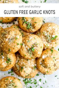 Gluten free garlic knots in a pile with parmesan and parsley.