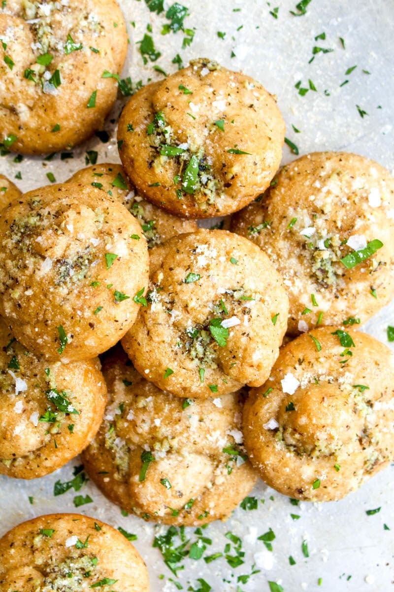 A pile of gluten free garlic knots on a sheet pan.