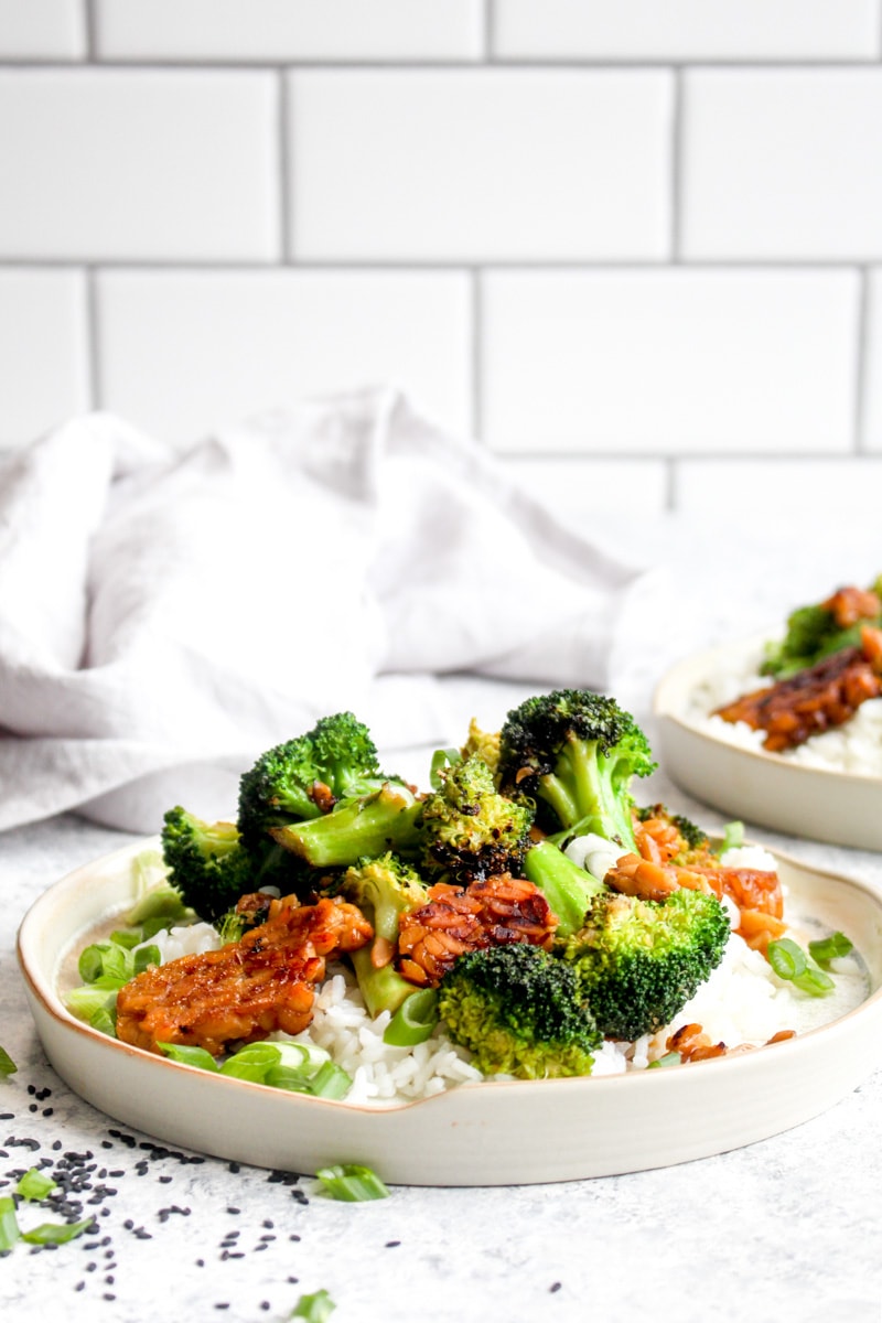 A plate of tempeh broccoli stir fry and rice. 