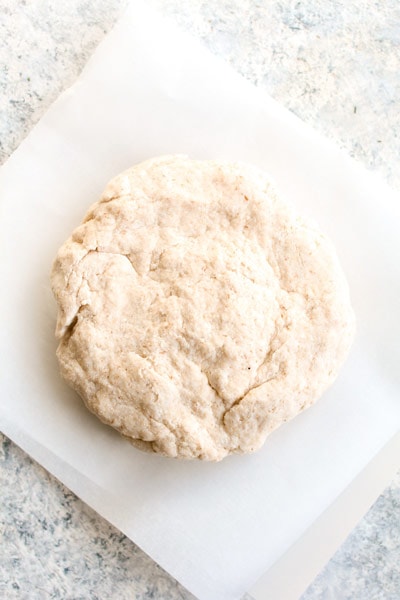 Paleo grain free tortilla dough on parchment paper.