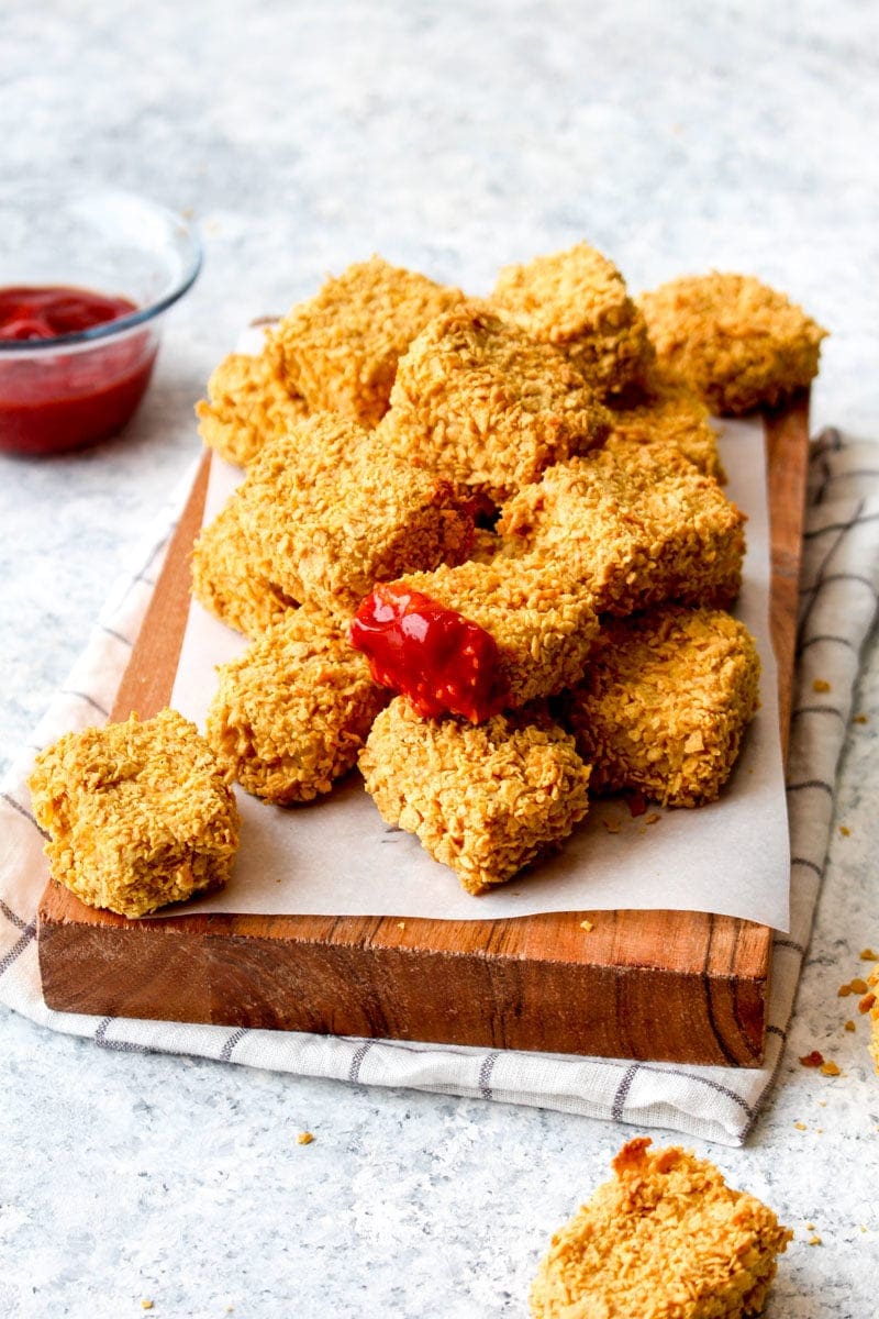 A pile of oven fried tofu with ketchup.