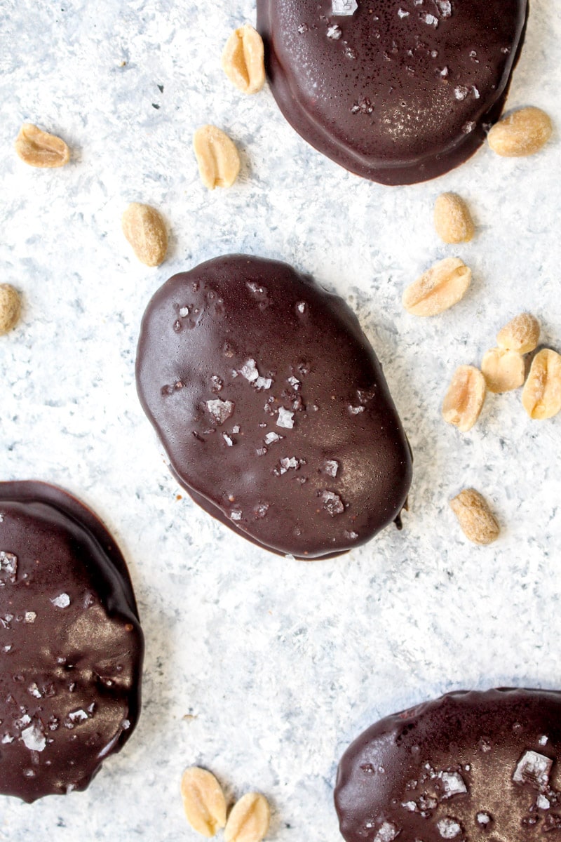 Healthy peanut butter eggs on a white background with peanuts.