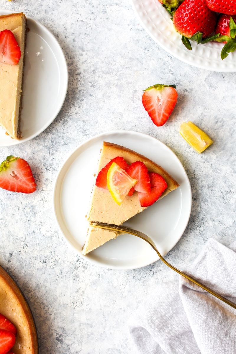 A slice of paleo cheesecake topped with berries.