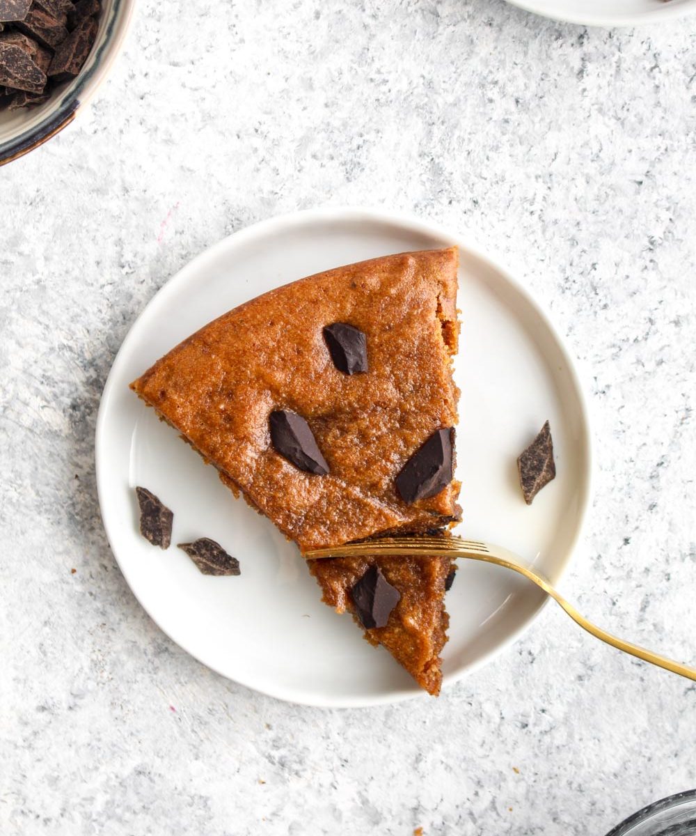 Almond butter chip snack cake with chocolate chunks and a gold spoon.