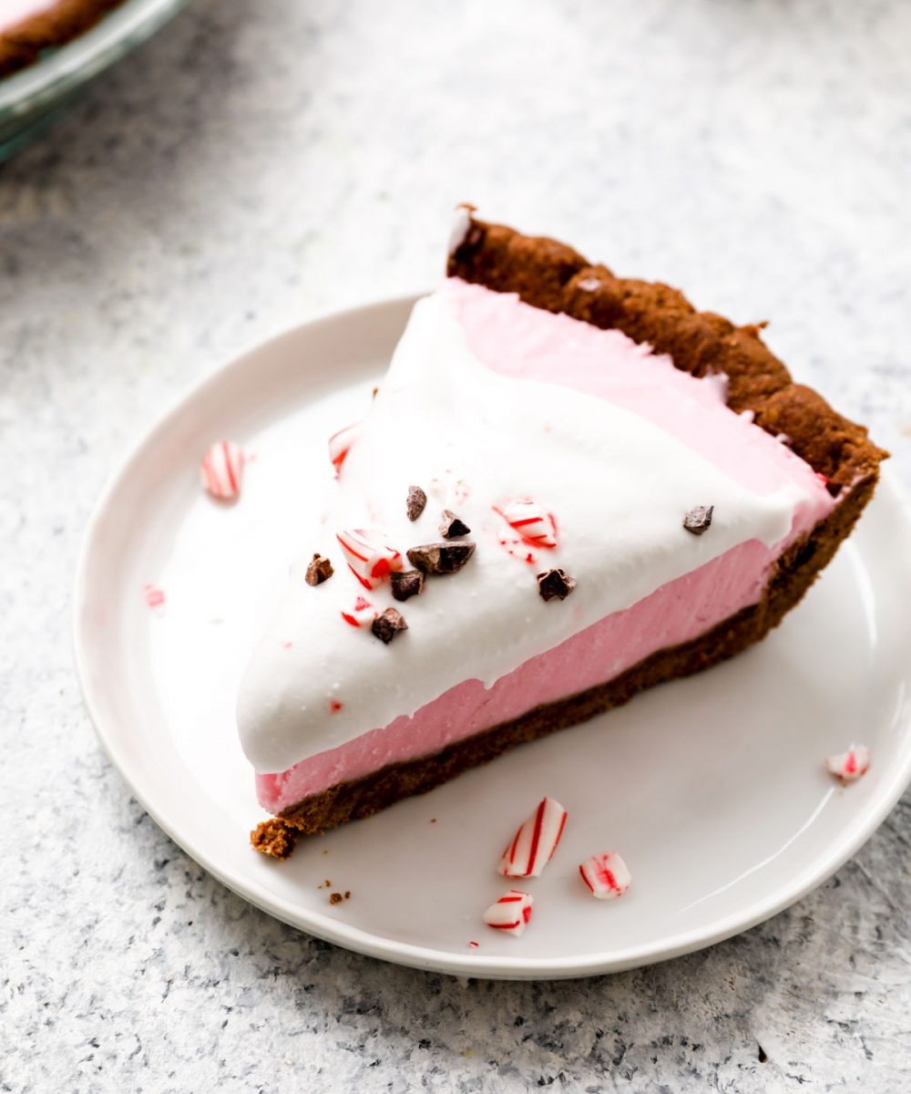 A slice of Vegan Peppermint Cream Pie with coconut whip.