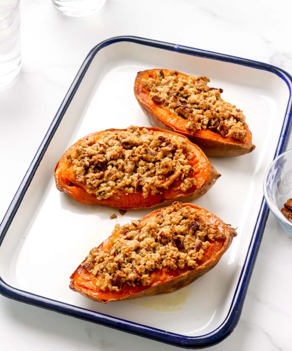 Three mini sweet potato casserole boats with crumble and pecans.