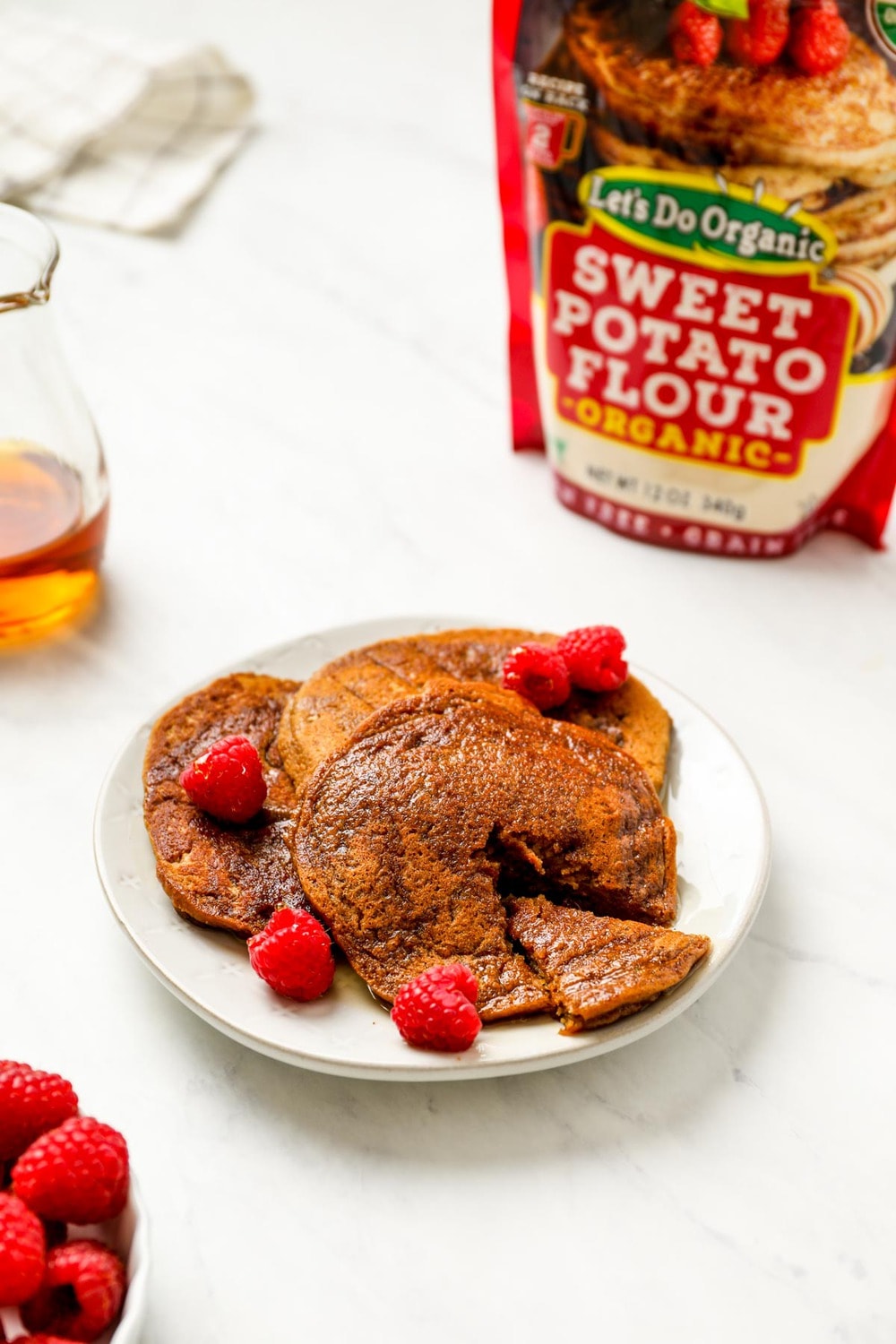 A bite out f a stack of sweet potato pancakes