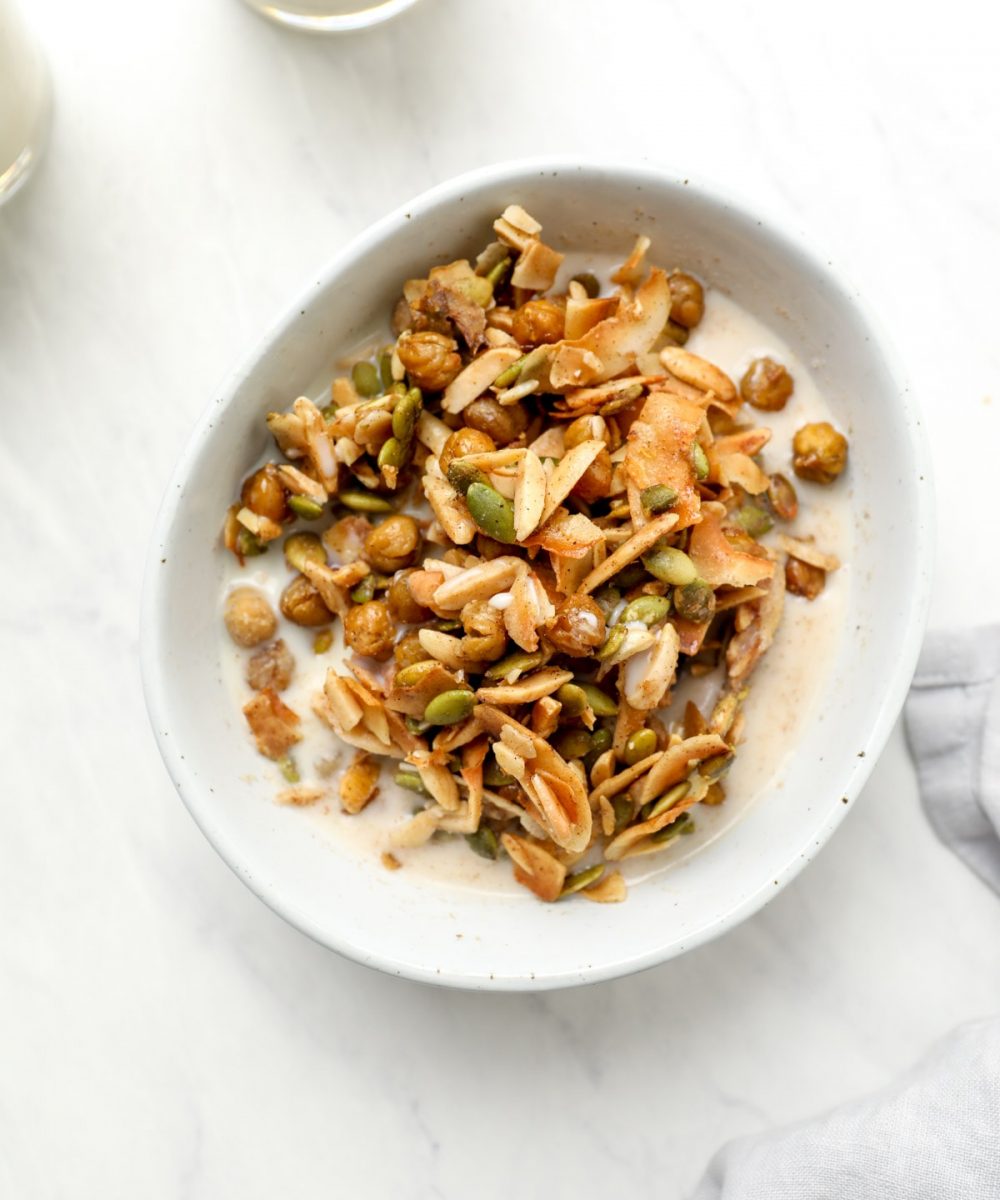 A bowl of grain free chickpea granola and vegan milk.