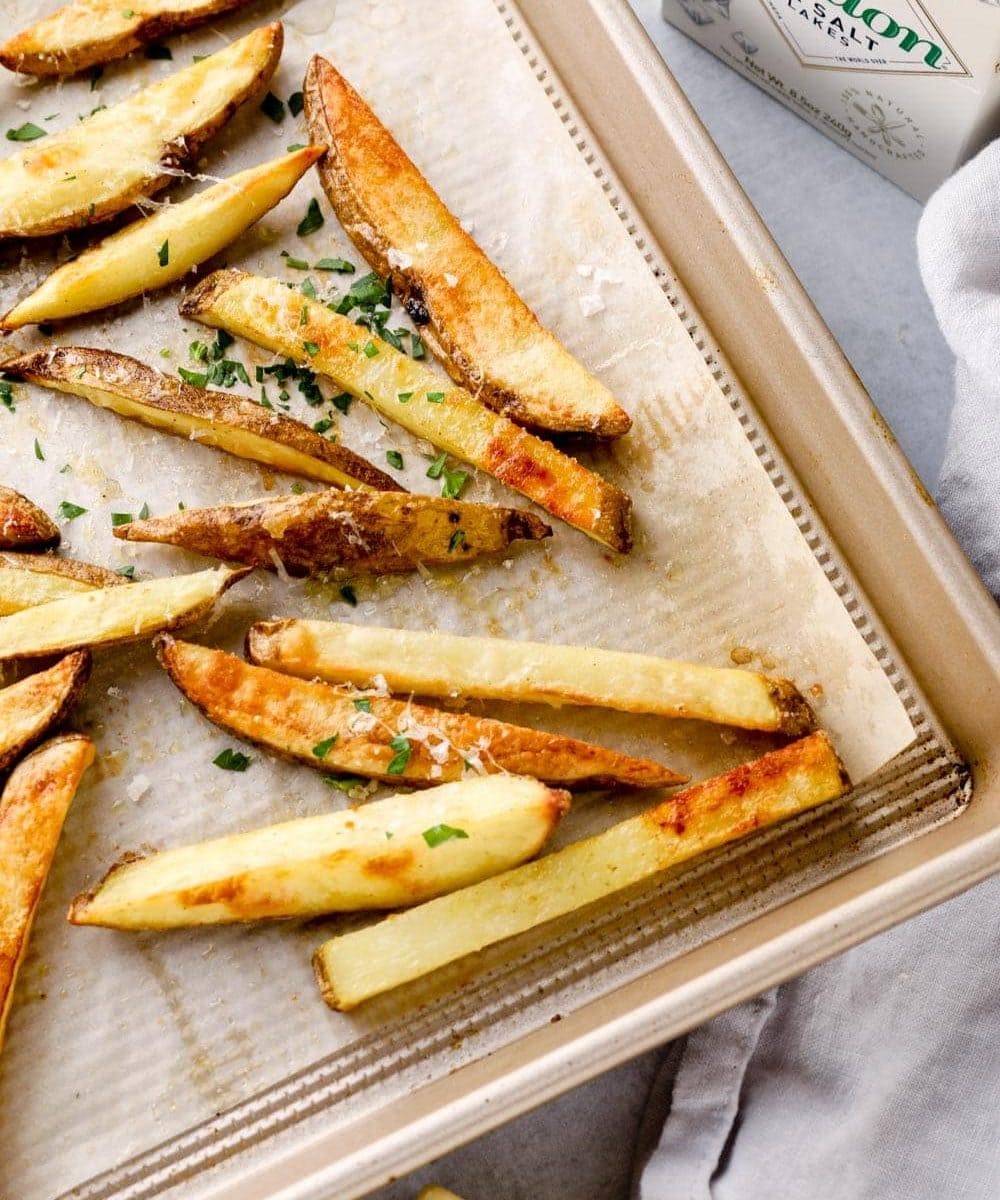 Truffle fries on a sheet pan with flaky maldon salt.
