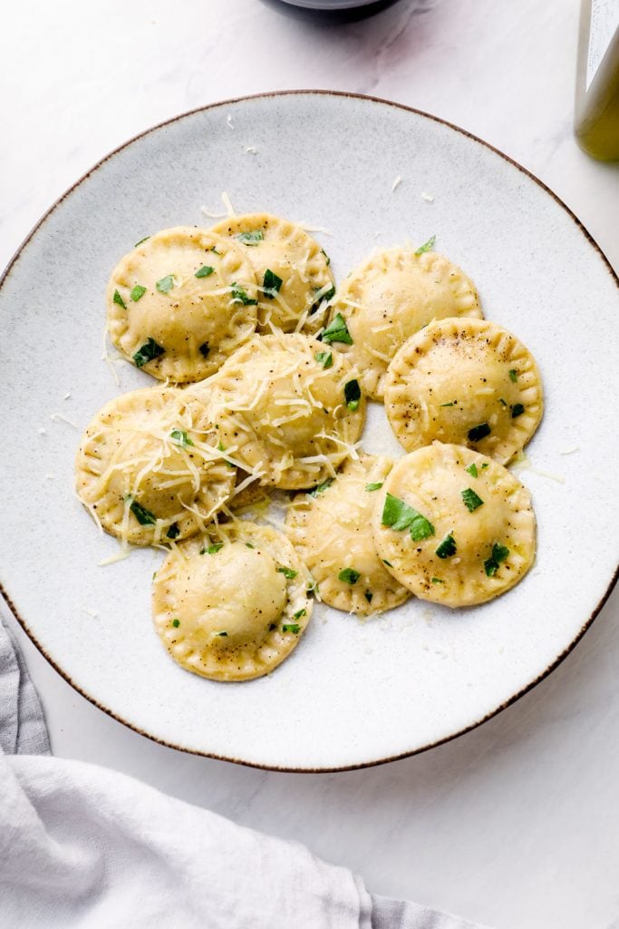 A plate of gluten free ravioli with olive oil and butter.